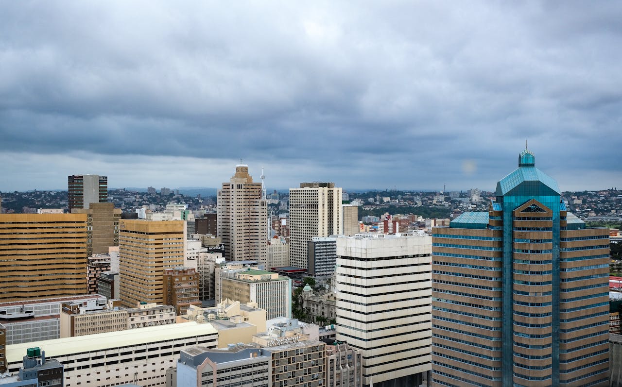 A stunning aerial view of Durban's modern skyline with high-rise buildings and an overcast sky.